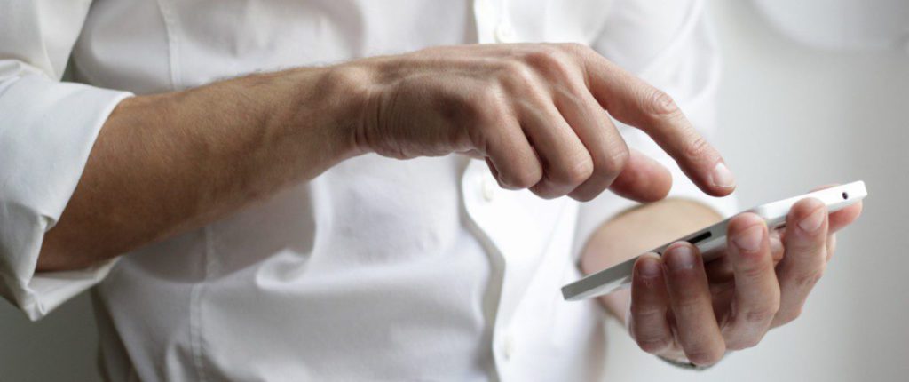 person holding white Android smartphone in white shirt